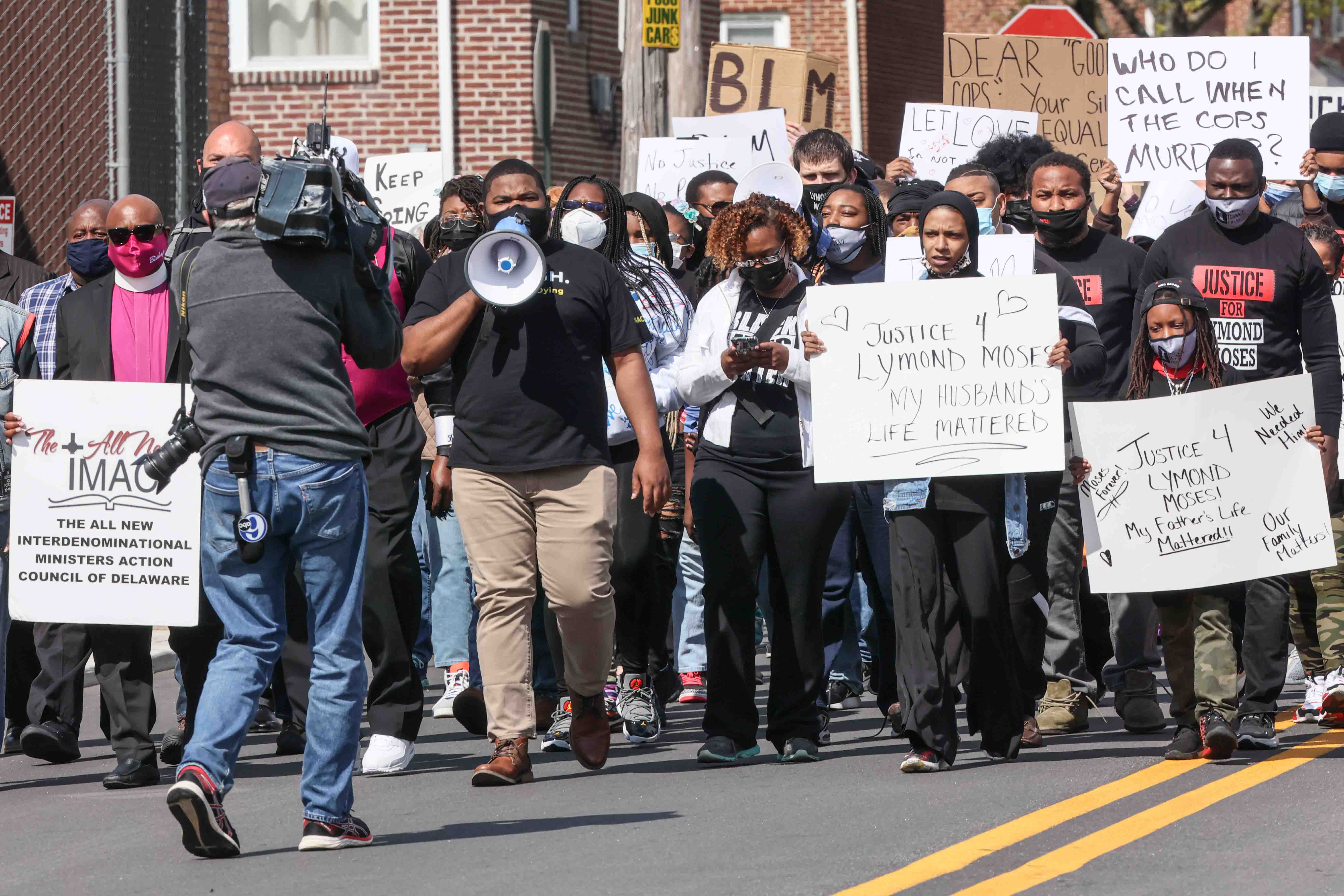 Community organizer Coby Owens leads members of the community on a march to Rodney Square during a We Still Can’t Breathe March Against Police Brutality