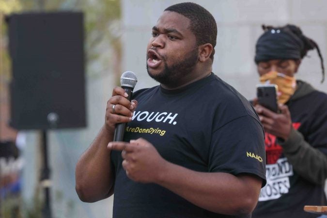 Community organizer Coby Owens gives remarks during a We Still Can’t Breathe March Against Police Brutality