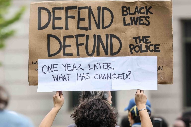 A protester holds up a sign during a We Still Can’t Breathe March