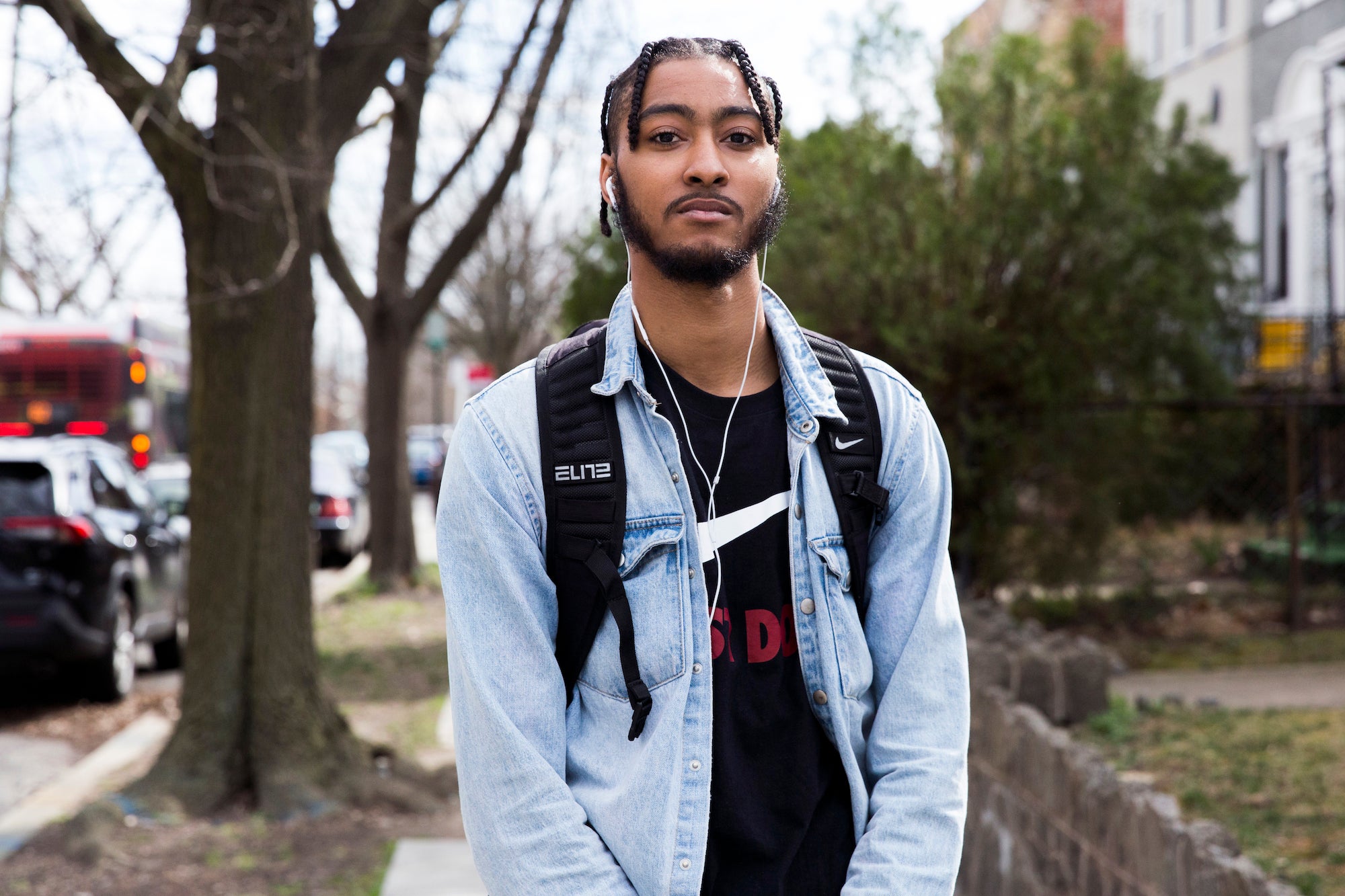 Christopher Moses stands on the sidewalk