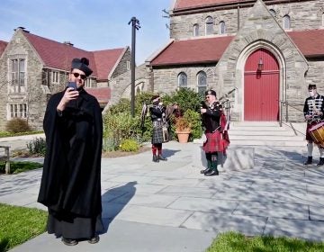 Rev. Jarrett Kerbel (left) leads a three-person band as they bring Easter hymns to Chestnut Hill on April 12, 2020. (Emily Cohen for WHYY)