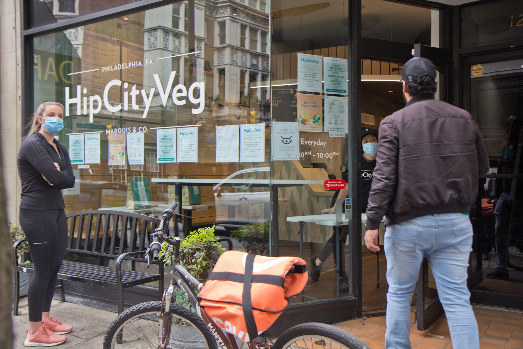 A person opens the door to HipCityVeg in Center City.
