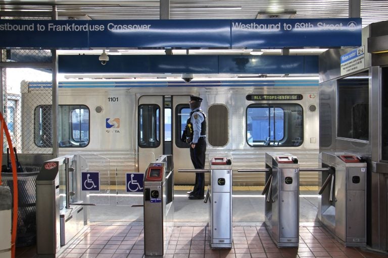 A SEPTA police officer stands on the platform of the Somerset stop