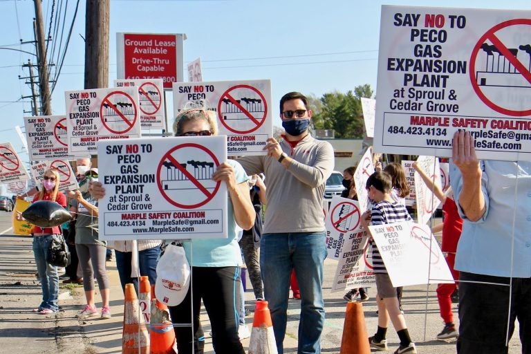 Greg Fat (center), a leader of Marple Safety Coalition, joins protesters at the intersection of Sproul and Cedar Grove roads in Marple Township, Pa, where PECO wants to build a natural gas expansion plant. (Emma Lee/WHYY)