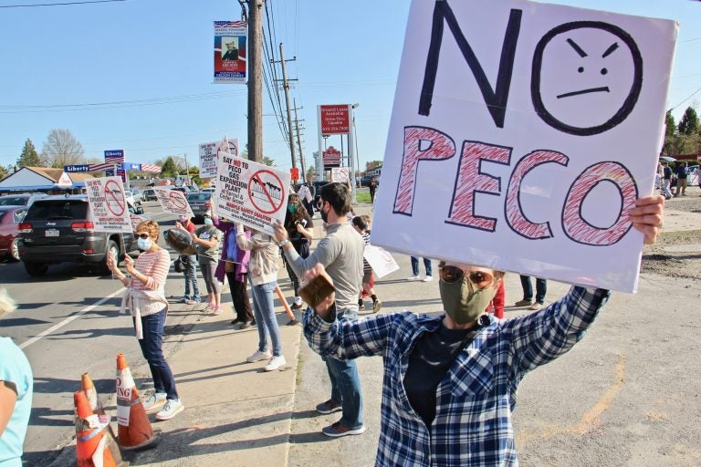 Person holds a sign that reads, 