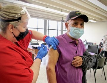 Eduardo Delgado gets his COVID-19 vaccination from Gail Bagnato