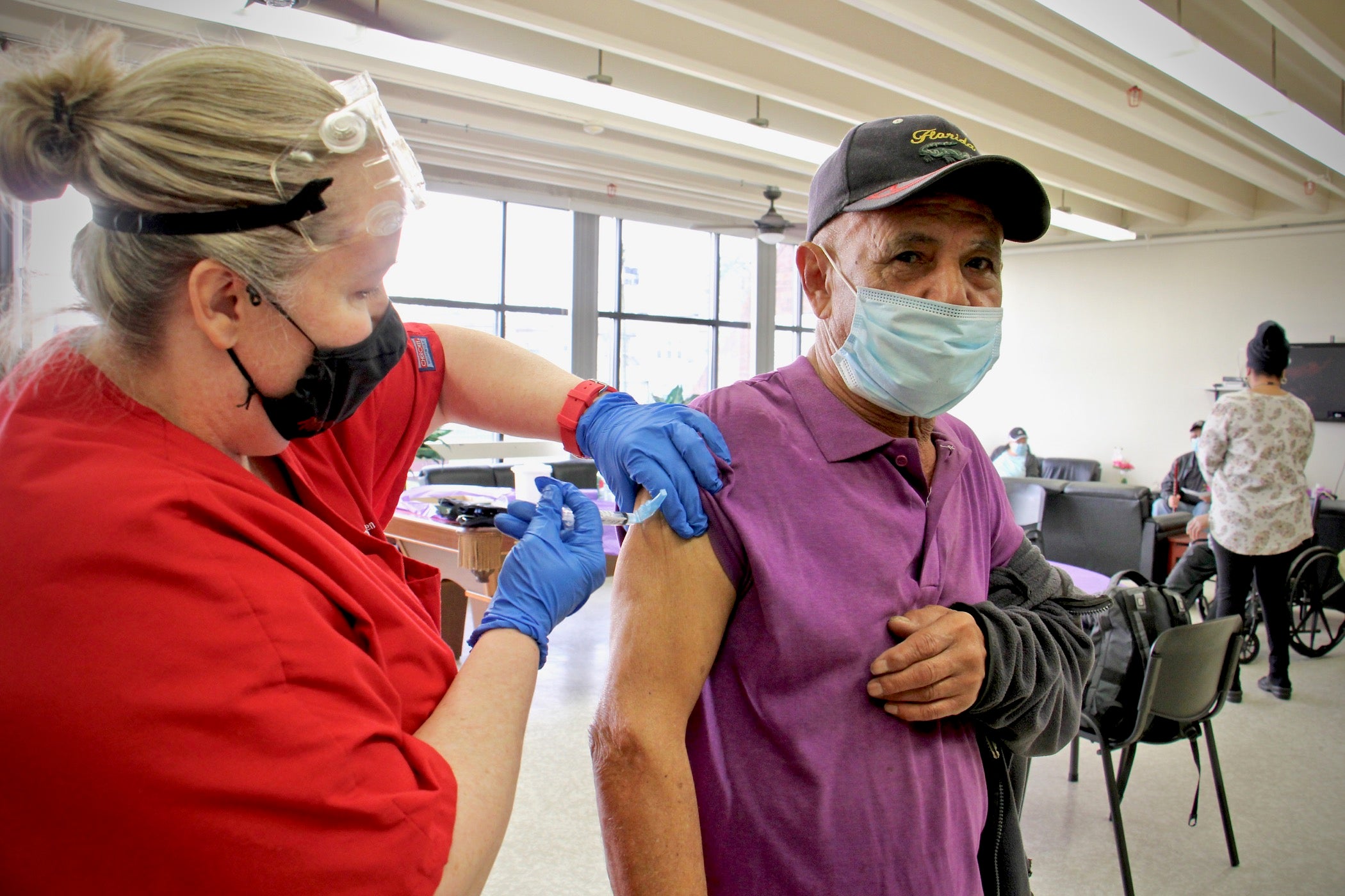 Eduardo Delgado, 79, gets his COVID-19 vaccination from Gail Bagnato