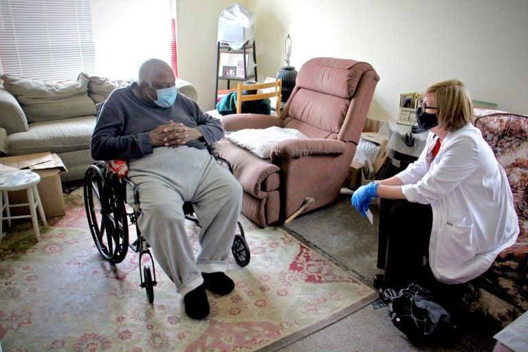 Rebecca Bryan of Rutgers School of Nursing sits with 86-year-old Turner Pittman