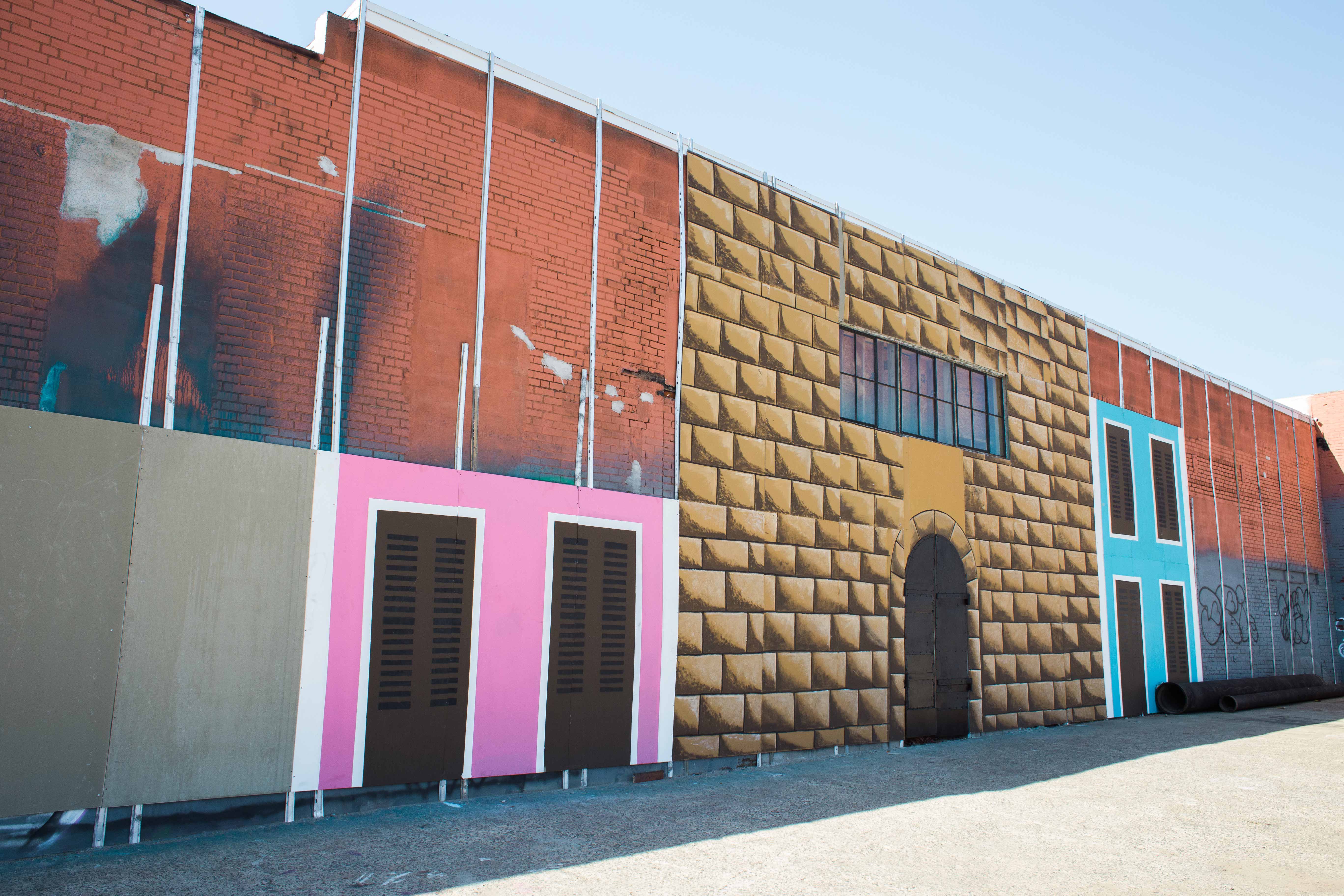 The building at La Placita features a mural in progress by a local artist and students from the neighborhood. (Becca Haydu for WHYY)