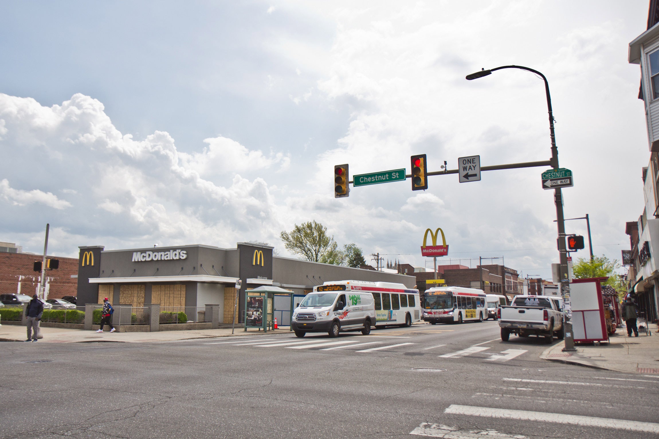 Shops on 52nd Street in West Philadelphia were mostly open on April 21, 2021, the day after the guilty verdict in the trial of Derek Chauvin was delivered. (Kimberly Paynter/WHYY)