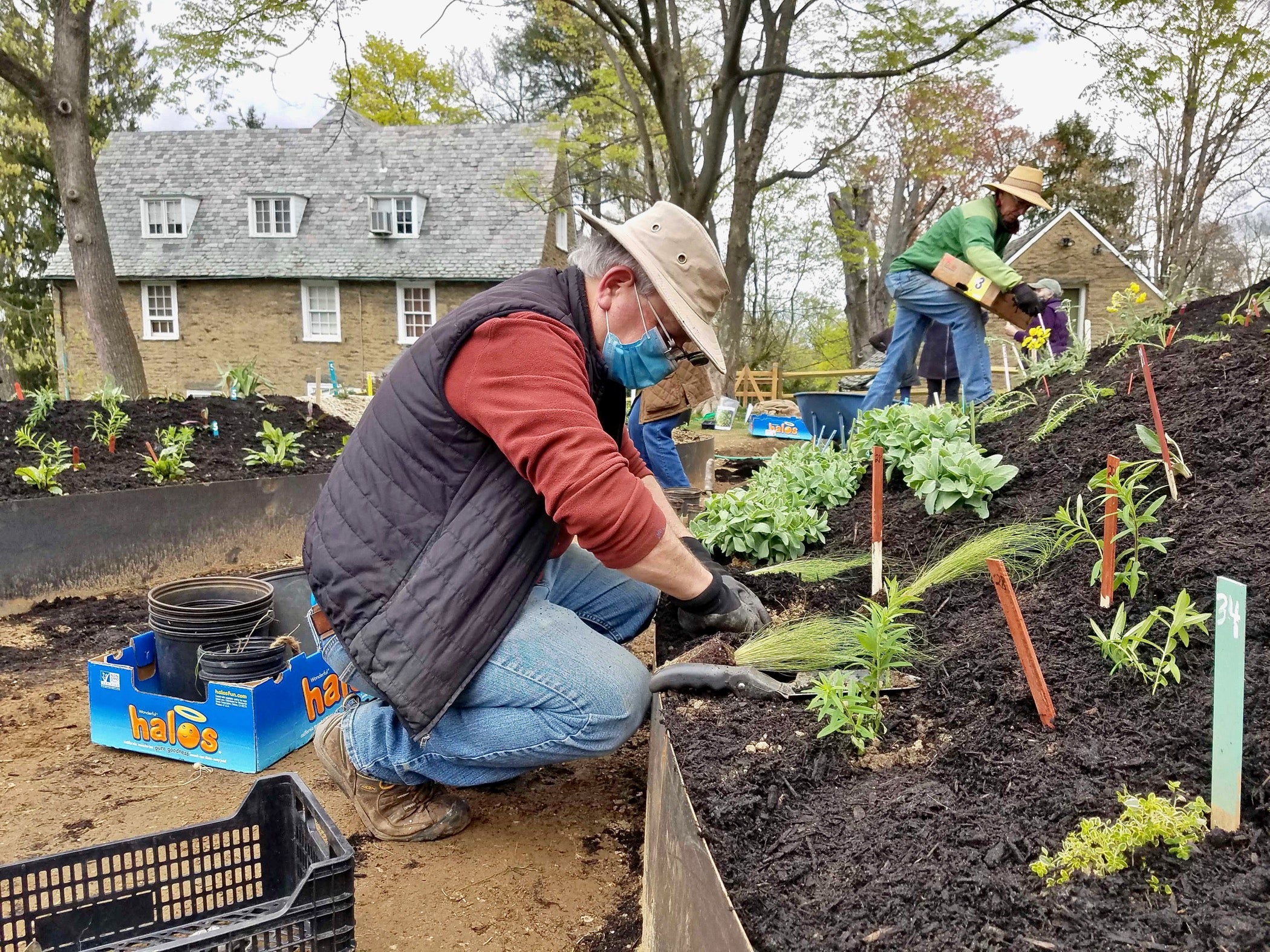 Mark Klempner helps to plant a hugel mound at the Woodmere Art Museum