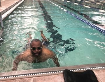 Omar James Brown has autism. He does his laps in the pool but gets excited most when talking about playing basketball. (Cris Barrish/WHYY)