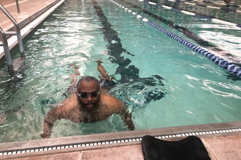 Omar James Brown has autism. He does his laps in the pool but gets excited most when talking about playing basketball. (Cris Barrish/WHYY)