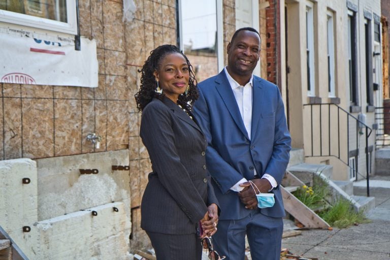 Sandra Dungee Glenn and Anthony Fullard in front of a West Philly property