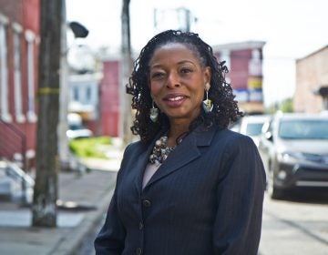Sandra Dungee Glenn in front of a West Philly property