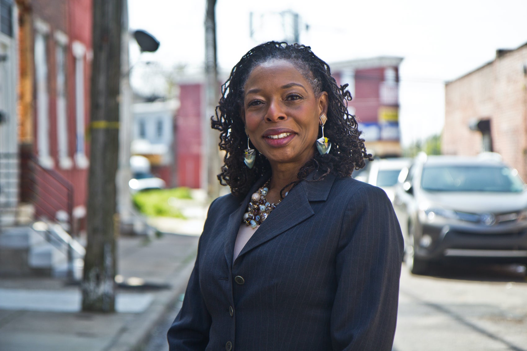 Sandra Dungee Glenn in front of a West Philly property