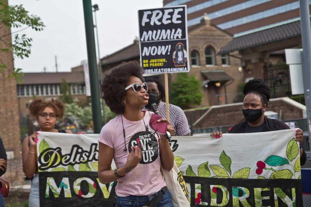 Black Lives Matter organizer YahNé Ndgo protested outside Penn Museum on April 28, 2021, over the museum’s mistreatment of the remains of children Tree and Delisha Africa who were killed when the city bombed the MOVE organization’s headquarters in 1985. (Kimberly Paynter/WHYY)