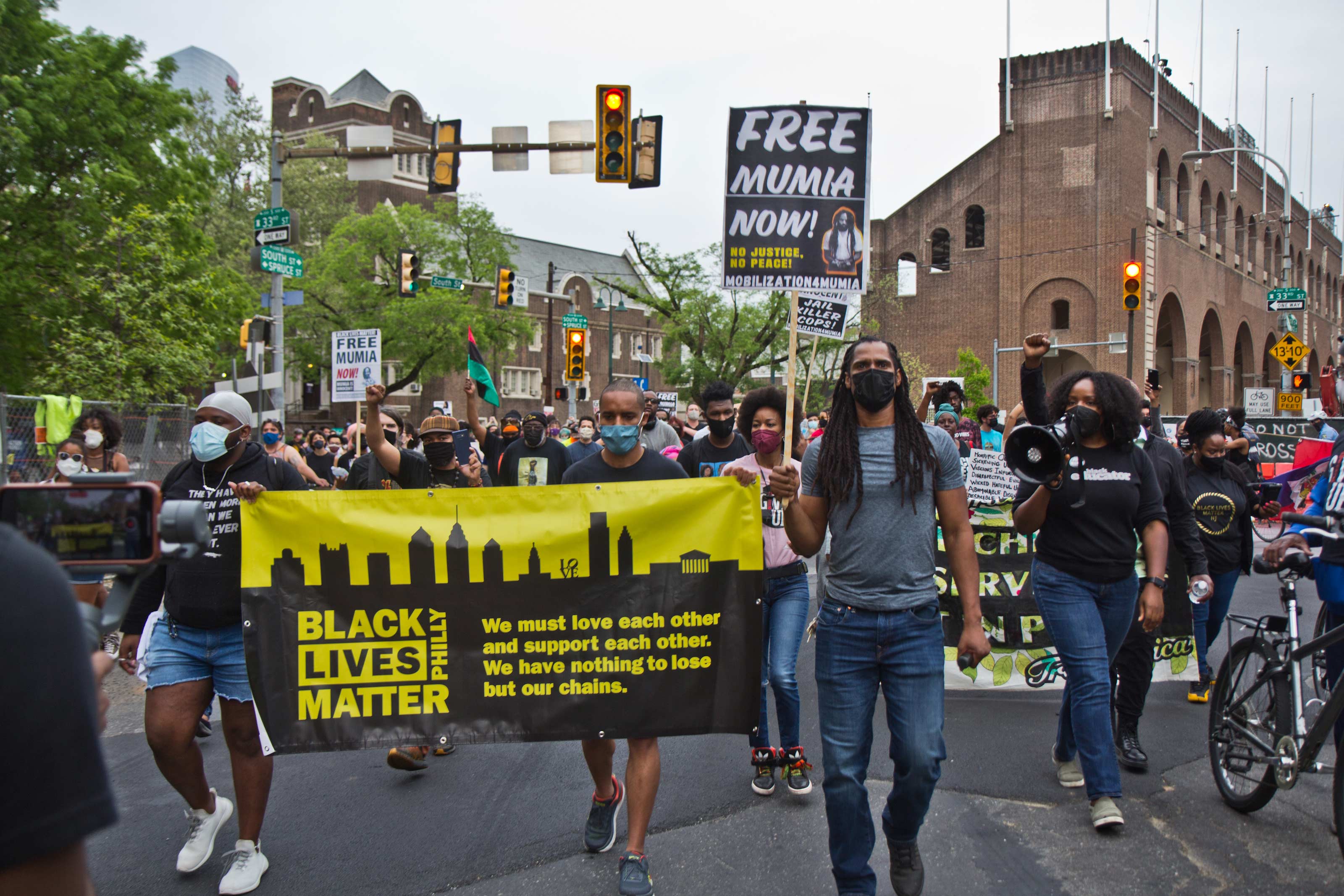 Protesters marched on the University of Pennsylvania’s campus on April 28, 2021, over Penn Museum’s mistreatment of the remains of children Tree and Delisha Africa who were killed when the city bombed MOVE’s headquarters in 1985. (Kimberly Paynter/WHYY)