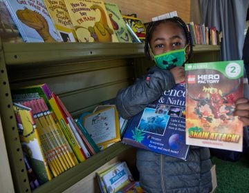 Six-year-old Melvin chose two books from Treehouse Books’ mobile library