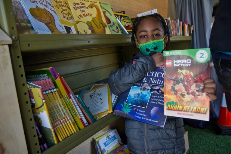 Six-year-old Melvin chose two books from Treehouse Books’ mobile library