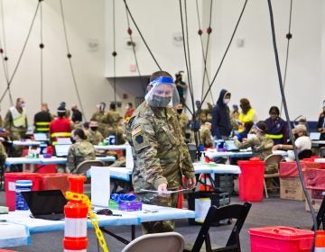 Members of the National Guard administer COVID-19 vaccines at the Esperanza Community Vaccination Center in North Philadelphia on April 9, 2021. (Kimberly Paynter/WHYY)