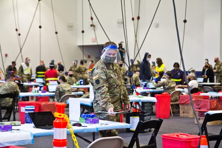 Members of the National Guard administer COVID-19 vaccines at the Esperanza Community Vaccination Center in North Philadelphia on April 9, 2021. (Kimberly Paynter/WHYY)