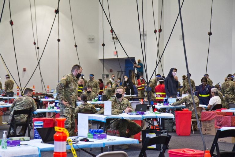 Members of the National Guard administer COVID-19 vaccines at the Esperanza Community Vaccination Center in North Philadelphia on April 9, 2021. (Kimberly Paynter/WHYY)