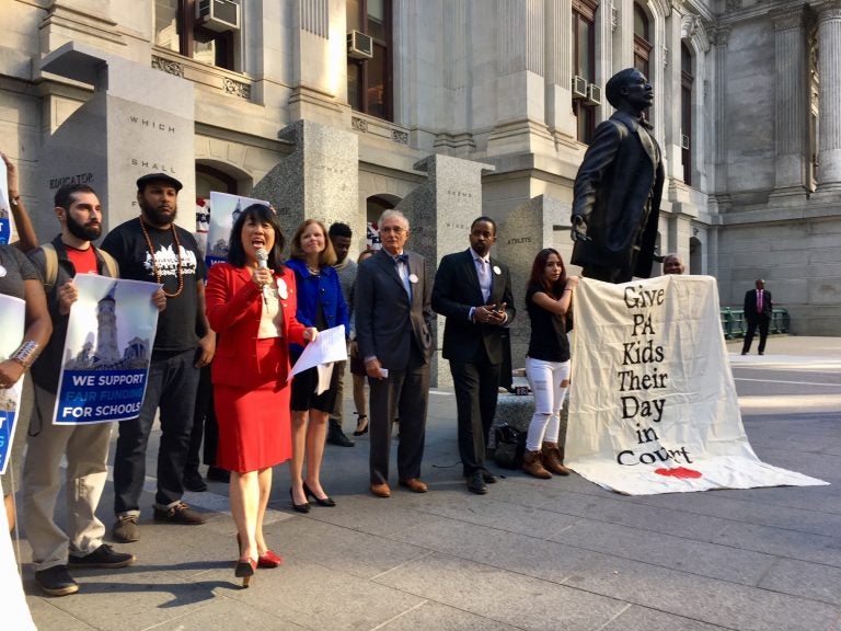 In 2018, advocates talk to the press outside Philadelphia’s city hall after a court appearance in the fair funding case now scheduled to go to trial in September. (Darryl C. Murphy/The Notebook)