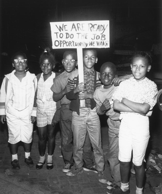 A photo from Jack T. Franklin's AAMP collection shows young Black boys with a sign that says, "We are ready to do the job"