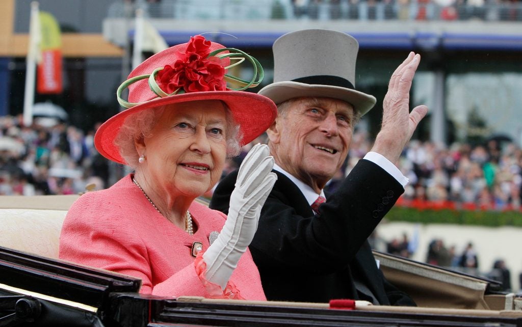 Queen Elizabeth II with Prince Philip arrive by horse drawn carriage