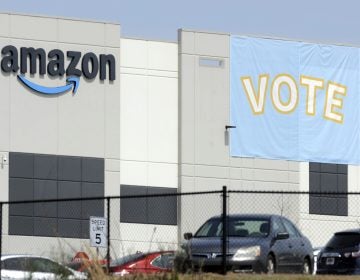 In this Tuesday, March 30, 2021 file photo, a banner encouraging workers to vote in labor balloting is shown at an Amazon warehouse in Bessemer, Ala.