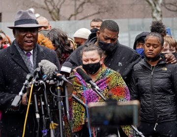 Katie Wright, center, the mother of Daunte Wright, and other family and friends gather during a news conference Tuesday, April 13, 2021, in Minneapolis as family attorney Ben Crump, left, speaks. Daunte Wright, 20, was shot and killed by police Sunday after a traffic stop in Brooklyn Center, Minn. (AP Photo/Jim Mone)