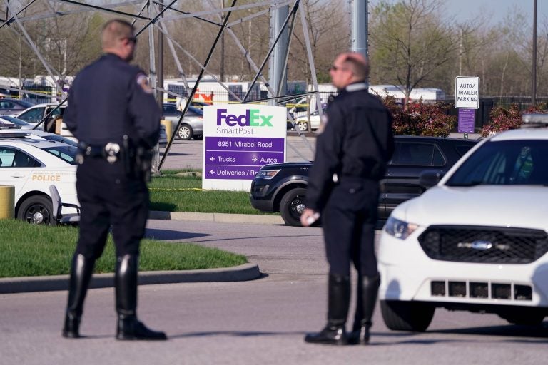 Police stand near the scene where multiple people were shot at the FedEx Ground facility early Friday morning, April 16, 2021, in Indianapolis. A gunman killed eight people and wounded several others before apparently taking his own life in a late-night attack at a FedEx facility near the Indianapolis airport, police said, in the latest in a spate of mass shootings in the United States after a relative lull during the pandemic. (AP Photo/Michael Conroy)