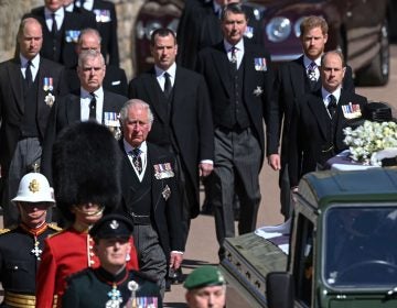From front left, Britain's Prince Charles, Prince Andrew. Prince Edward, Prince William, Peter Phillips, Prince Harry, Earl of Snowdon and Tim Laurence follow the coffin the coffin makes it's way past the Round Tower during the funeral of Britain's Prince Philip inside Windsor Castle in Windsor, England Saturday April 17, 2021. (Leon Neal/Pool via AP)