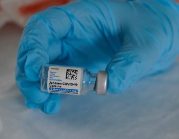 In this March 3, 2021, file photo, U.S. Army medic Kristen Rogers, of Waxhaw, N.C., holds a vial of the Johnson & Johnson COVID-19 vaccine in North Miami, Fla. (AP Photo/Marta Lavandier)