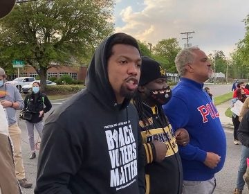 In this image taken from video, Quentin Jackson, regional director for the National Black Caucus of Local Elected Officials, addresses protesters blocking Business U.S. 17 in Elizabeth City, N.C., on Thursday, April 22, 2021. (AP Photo/Allen G. Breed)