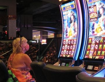 File photo: A woman plays a slot machine at the Golden Nugget casino in Atlantic City N.J. in this July  2, 2020 file photo. (AP Photo/Wayne Parry, FILE)