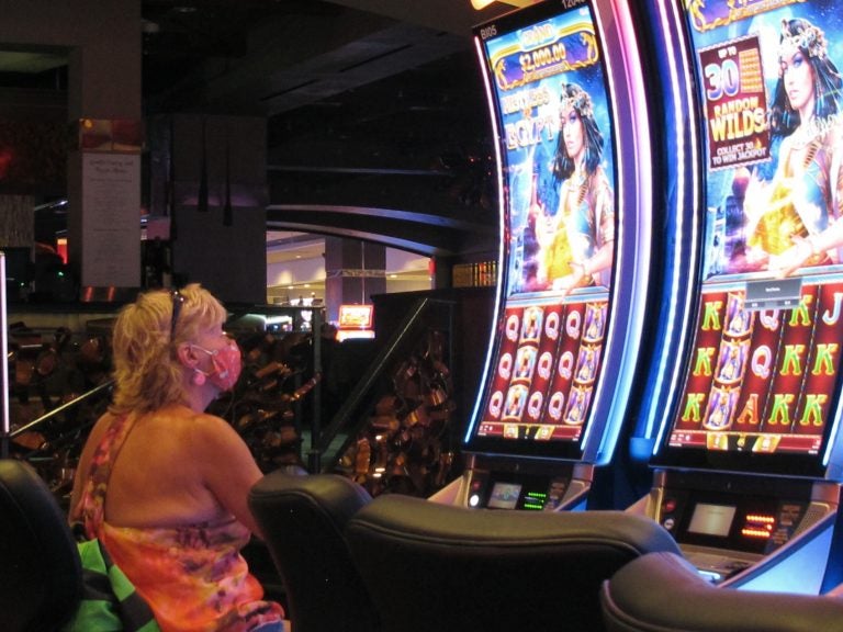 File photo: A woman plays a slot machine at the Golden Nugget casino in Atlantic City N.J. in this July  2, 2020 file photo. (AP Photo/Wayne Parry, FILE)