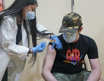 Alejandro Garcia, 16, receives his first dose of the Pfizer COVID-19 vaccine