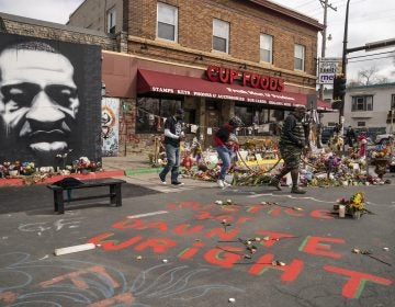 Visitors view a memorial to George Floyd as a new addition commemorating Daunte Wright is displayed outside Cup Foods