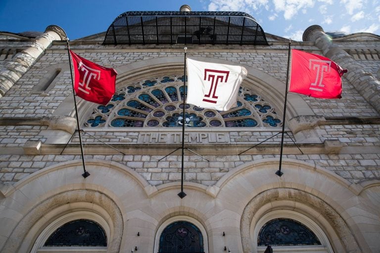 Flags wave in the wind from a building on the at Temple University campus in Philadelphia, Tuesday, Oct. 10, 2017. (AP Photo/Matt Rourke)