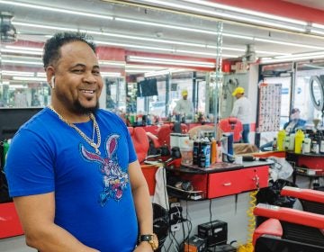 Raymon “La Salsa” Rincón inside of his shop, which he has owned since 2007. | Raymon “La Salsa” Rincón dentro de su tienda, de la que es propietario desde 2007. (Photo by Bernardo Morillo/WHYY)