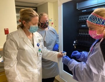 From left, Dr. Marci Drees reviews respiratory samples with scientists Alexa Pierce-Matlack and Stephanie Levin at Christiana Hospital's microbiology laboratory. (Courtesy of Christiana Care)