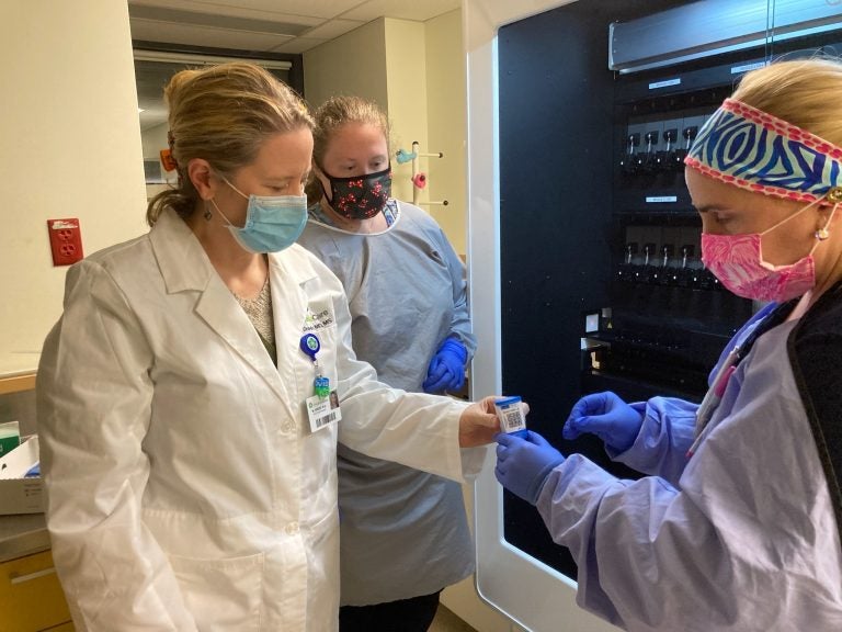 From left, Dr. Marci Drees reviews respiratory samples with scientists Alexa Pierce-Matlack and Stephanie Levin at Christiana Hospital's microbiology laboratory. (Courtesy of Christiana Care)