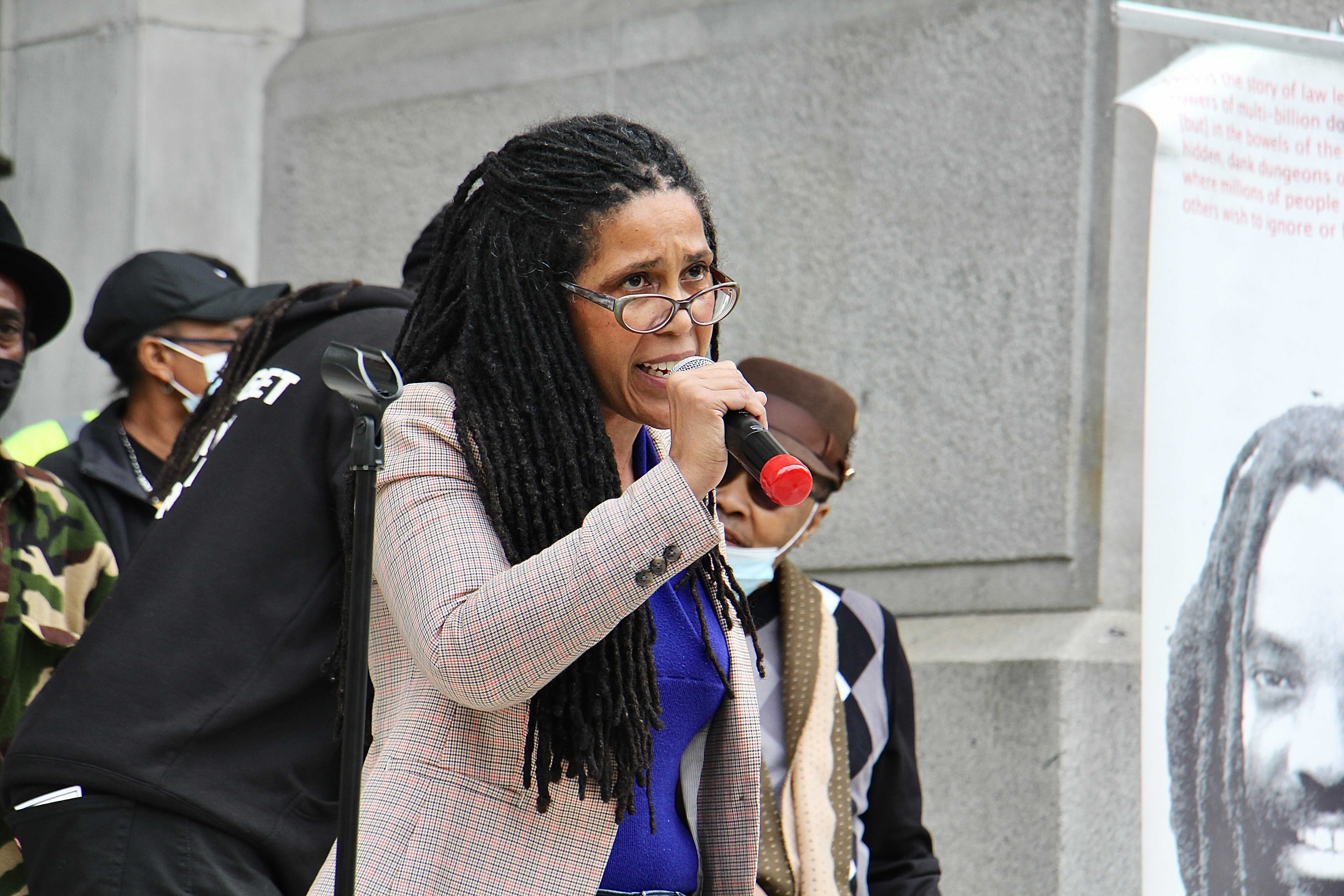 Johanna Fernandez, whose film, ‘’Justice on Trial,’’ disputes Mumia’s conviction, speaks at a Free Mumia protest at City Hall. (Emma Lee/WHYY)