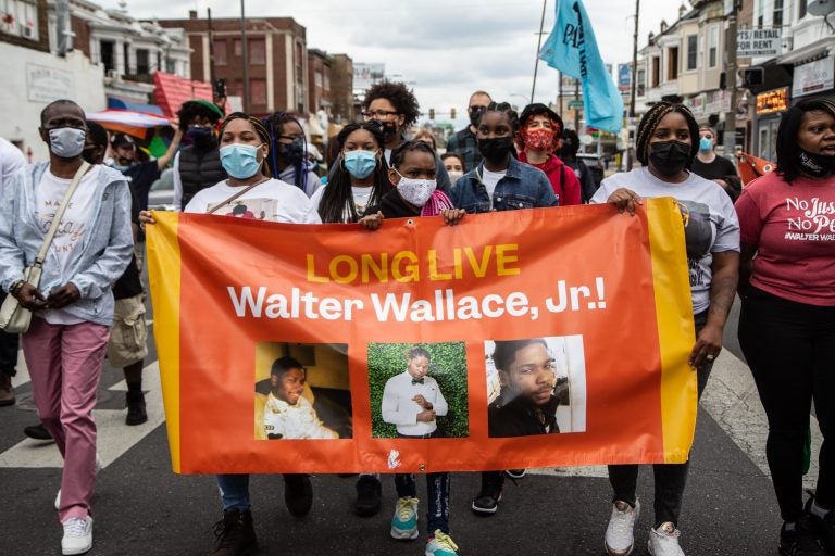 Protesters carry a banner in honor of Walter Wallace Jr.