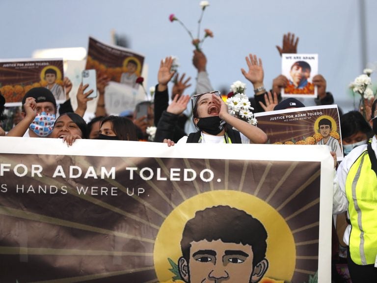 Demonstrators attend a peace walk honoring the life of 13-year-old Adam Toledo