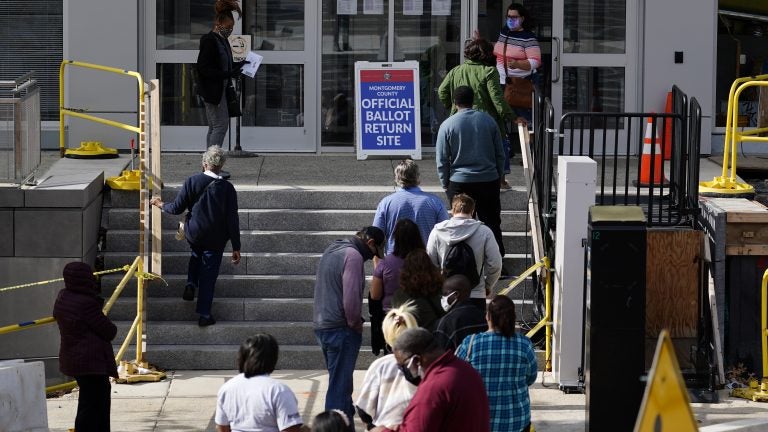 Residents line up outside the Montgomery County, Pa., Voter Services office, Monday, Oct. 19, 2020, in Norristown, Pa. Monday is the last day in Pennsylvania to register to vote in the Nov. 3 election in which the presidential battleground state is playing a central role in the contest between President Donald Trump and former Vice President Joe Biden. (AP Photo/Matt Slocum)
