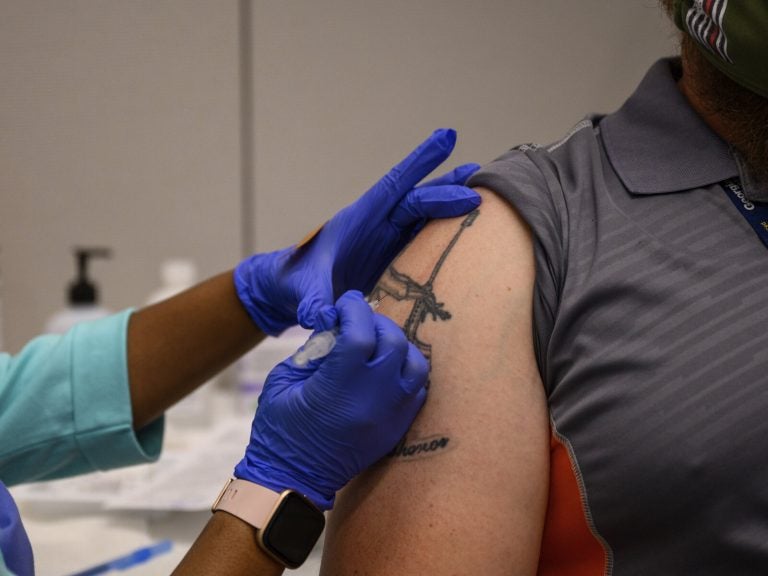 Adam Jackson receives a Pfizer COVID-19 vaccination