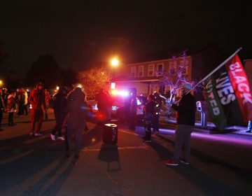 A crowd gathers to protest in the neighborhood where a Columbus police officer fatally shot a Black teenage girl